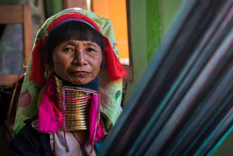 Old woman from Kayan (Long-neck) tribe in weaving workshop