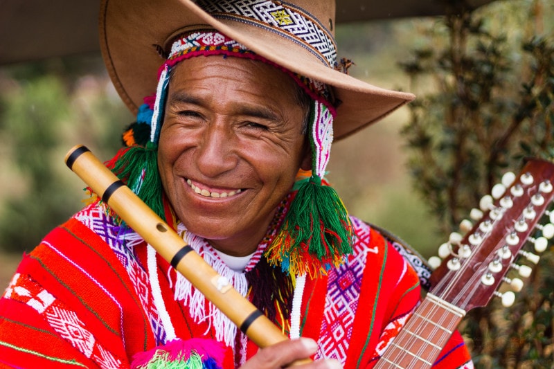 Peruvian musician plying flute and charangon
