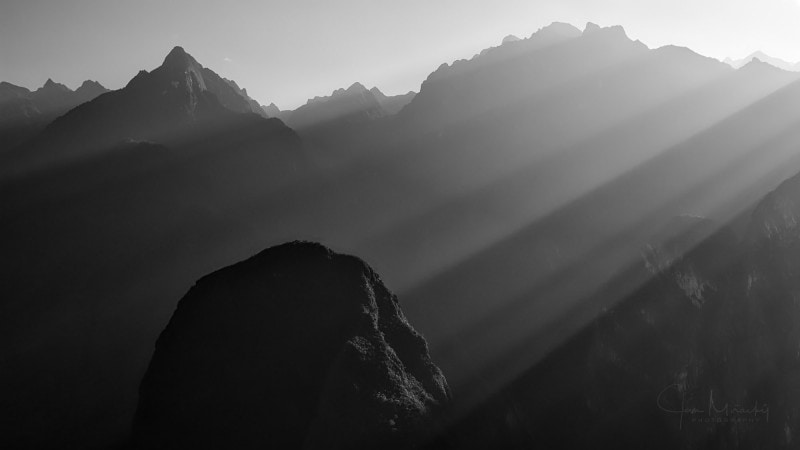 Morning sunbeams illuminating hills around Machu Picchu