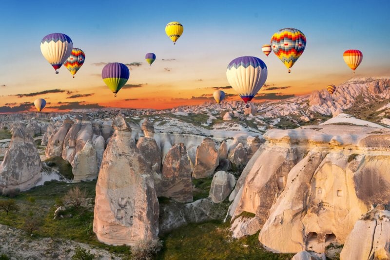 Hot air balloons at sunset over the cave town, Cappadocia, Turkey