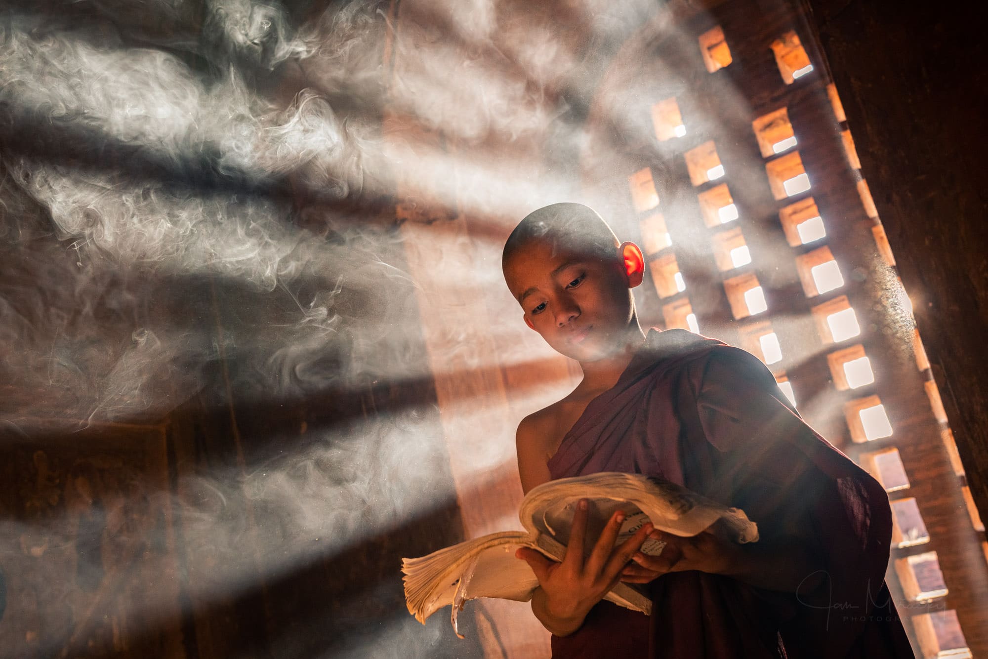 Novice monk reading a book