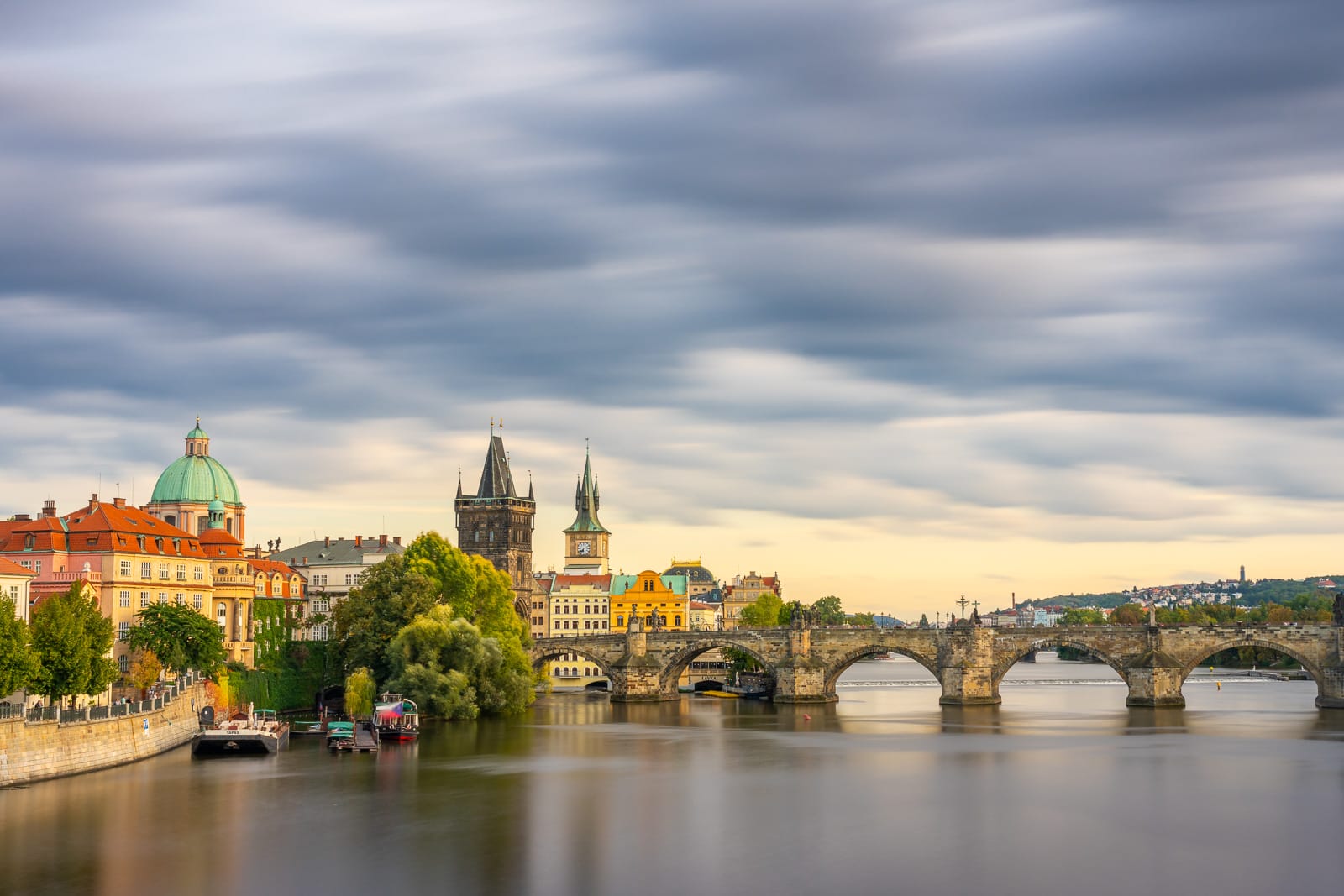 Long-exposure photo of Charles bridge with moving clouds, Prague