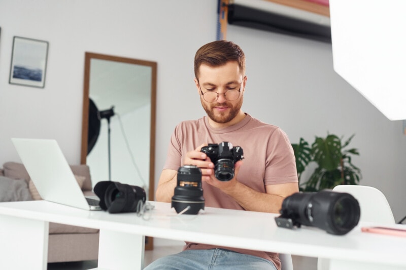 Photographer working sitting at his desk