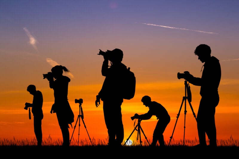 A group of photographers shooting at sunset